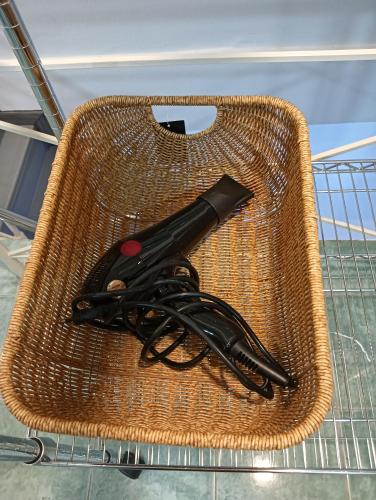 a wicker basket with a pair of scissors in it at Matinee House Hatyai in Hat Yai