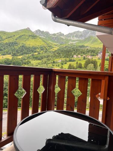 d'une table sur un balcon avec vue sur les montagnes. dans l'établissement Cosy - Saint François Longchamp, à Saint-François-Longchamp