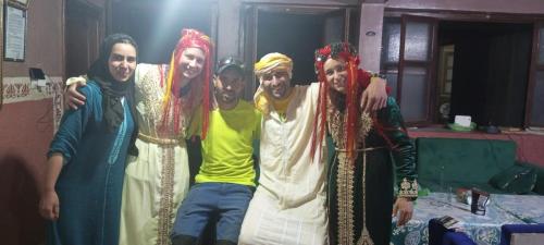 a group of four people posing for a picture at gîte taghia ahansal in Taghia