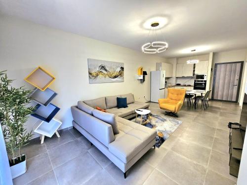 a living room with a couch and a table at Valentino Retreat in Tirana