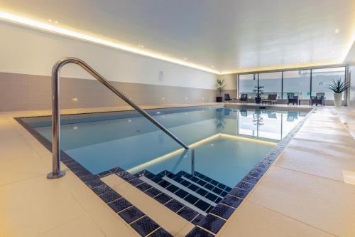 a large swimming pool in a building at 6 Putsborough - Luxury Apartment at Byron Woolacombe, only 4 minute walk to Woolacombe Beach! in Woolacombe