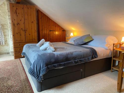 a bedroom with a bed with two towels on it at Banc Cottage in Pembrokeshire