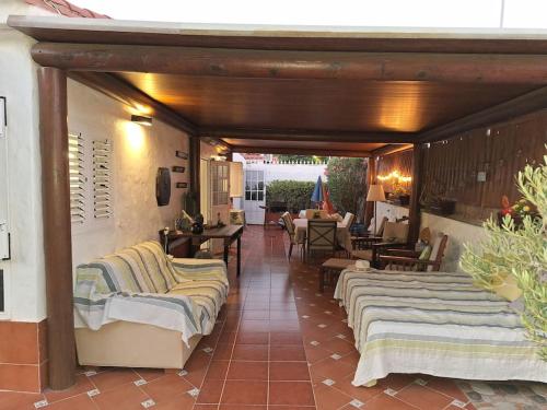 a room with several beds on a patio at Oasis Los Porches in Playa del Ingles