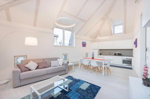 a living room with a couch and a table at Sweethome Gries - Con Garage in Bolzano