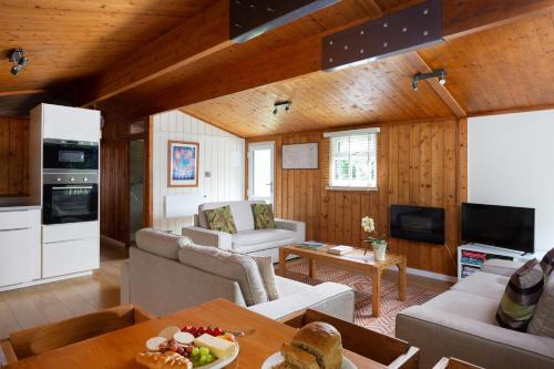 a living room with a couch and a table at Wensleydale Lodges in Masham