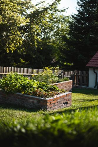 a brick garden in a yard next to a fence at Pod Vojtěchem - soukromý wellness apartmán in Wotitz