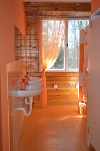a row of sinks in a bathroom with a window at Chata Alenka in Štítary