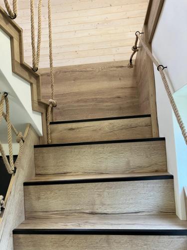 a set of wooden stairs with ropes at Chata u Járy in Trojanovice