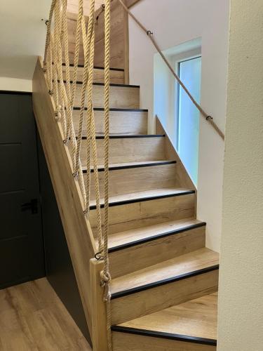 a staircase in a house with wooden treads at Chata u Járy in Trojanovice