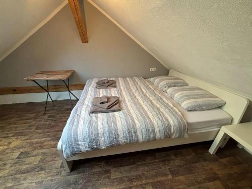 a bedroom with a bed with two slippers on it at Das kleine Haus Feldberg für Paare in Feldberg