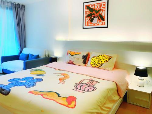 a bedroom with a bed with a painting on it at The Astra cozy living suite in Chiang Mai