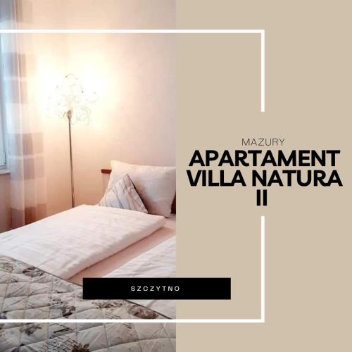 a poster of a bedroom with a bed and a lamp at Apartament Villa Natura II in Szczytno