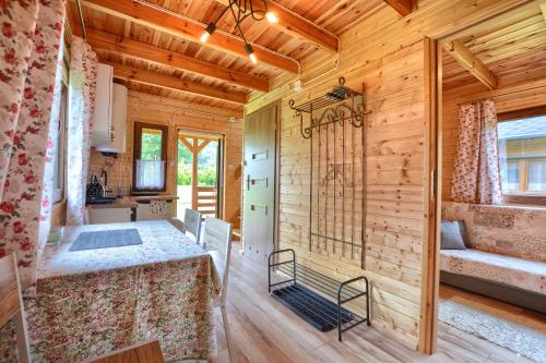 a dining room with a table in a wooden house at Domki U Szeryfa Dwernik in Dwernik