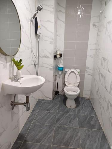 a bathroom with a sink and a toilet and a mirror at Proud Room &wifi 2 in Pattaya North