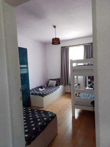 a room with two beds and a bunk bed at Apartman Dane Međugorje in Međugorje