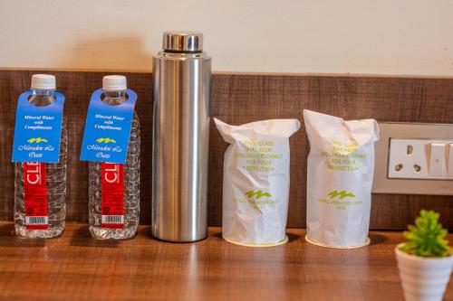 a counter with four bottles of food and a thermos at La Oasis by Meraden ,Goa in Anjuna
