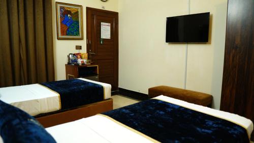 Postel nebo postele na pokoji v ubytování Orchid Inn by WI Hotel