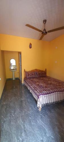 a bedroom with a bed and a ceiling fan at Batti Relax Point in Batticaloa