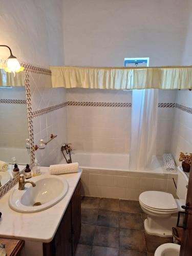 a bathroom with a sink and a tub and a toilet at Monte Santiago in Fronteira