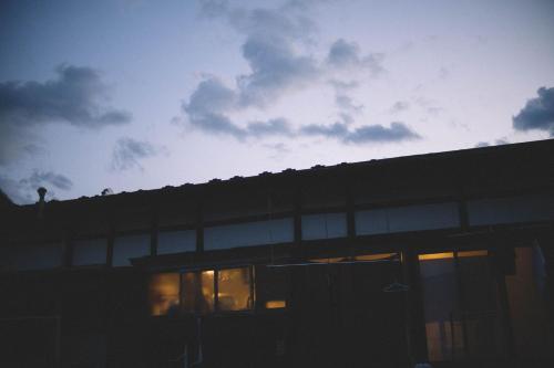 a building with windows with the sky in the background at hinatabocco guesthouse Japanese warehouse in Miyaki