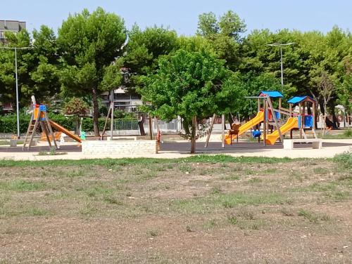a park with a playground with a slide at Green54oro in Santo Spirito