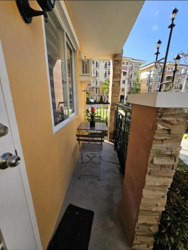 a balcony with a table and chairs on a building at Your Davao Home, Awaits You at Arezzo Place Davao! in Sasabayou