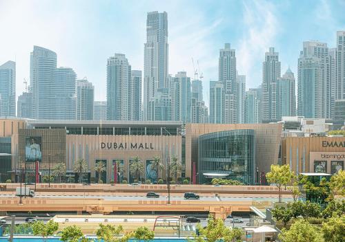 a view of a large city with buildings and a freeway at Stylish Burj khalifa view 5 Star 4BD Apartment in Downtown with Dubai Mall access - Brand New Apartment in Dubai