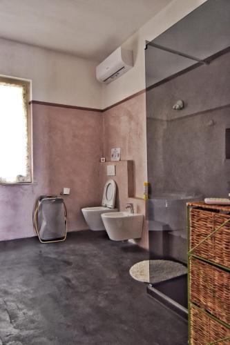 a bathroom with a sink and a toilet and a window at Tra gli ulivi da Giacinta in Varazze