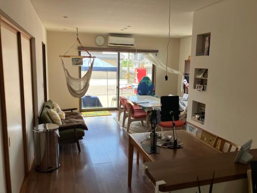 a living room with a table and a dining room at オルちゅーばーハウス一棟貸し#ホスト住居型民泊# in Edome-naka