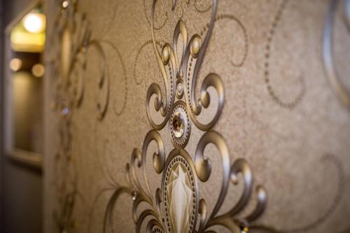 a close up of a metal object with designs on it at King's Resort - casino and hotels in Rozvadov