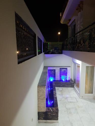 a house with a walkway with blue lights at Royal Palace Hotel in Islamabad