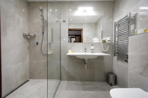 a bathroom with a shower and a sink and a shower at King's Resort - casino and hotels in Rozvadov