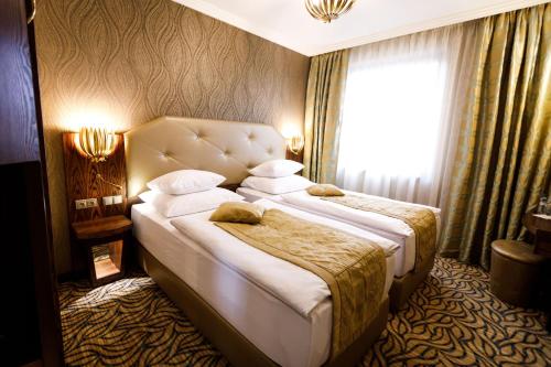 a hotel room with two beds and a window at King's Resort - casino and hotels in Rozvadov