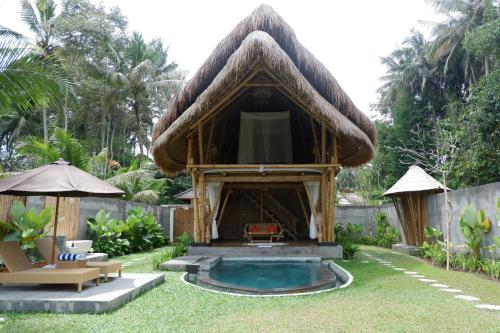 a small hut with a pool in a yard at Pitu, a Punggul Village Escape in Sangeh