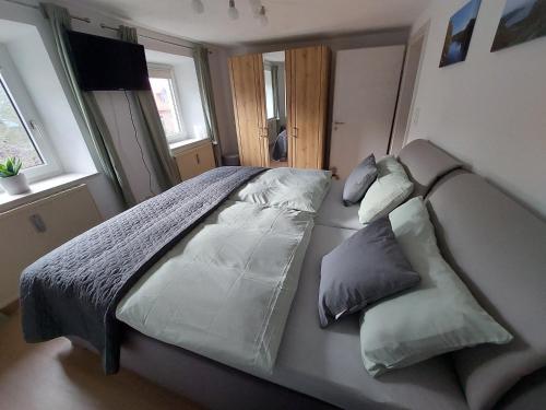a bed with two pillows on it in a bedroom at Haus Am Stadtschloss FeWo 3 Zimmer Küche Bad in Lichtenfels