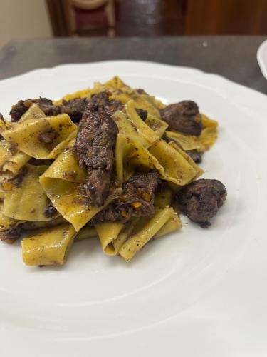 a white plate of food on a table at Relais Osteria Dell'Orcia in Bagno Vignoni