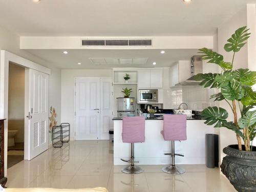 a kitchen with purple chairs and a counter top at Patong - The Unity Seaview & Mountain Residence in Patong Beach