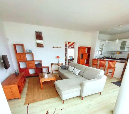 a living room with a white couch and a table at Casa Betania ocean view in La Orotava