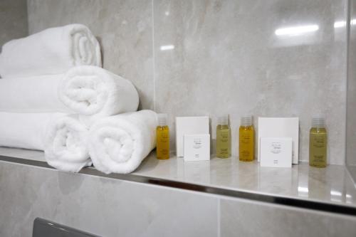 a bunch of towels on a shelf in a bathroom at King's Resort - casino and hotels in Rozvadov