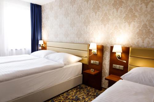 a hotel room with two beds and a window at King's Resort - casino and hotels in Rozvadov