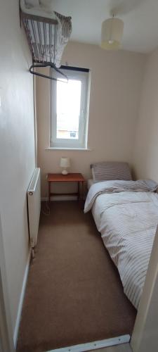 a small bedroom with a bed and a window at Sheffield Arena Meadowhall Interchange with off road free parking & CCTV in Sheffield