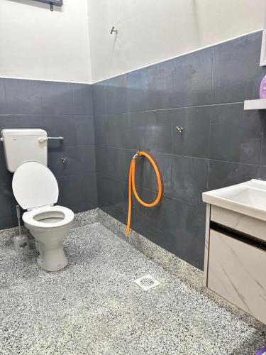 a bathroom with a toilet and a sink at Homestay White Aqil in Kampong Paya Pulai