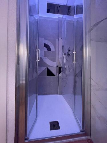 a shower with a glass door in a bathroom at Tiffany House in Marina di Massa