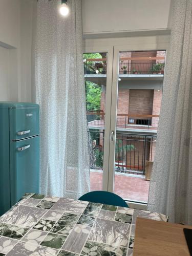 a bedroom with a bed and a window with a view at Tiffany House in Marina di Massa