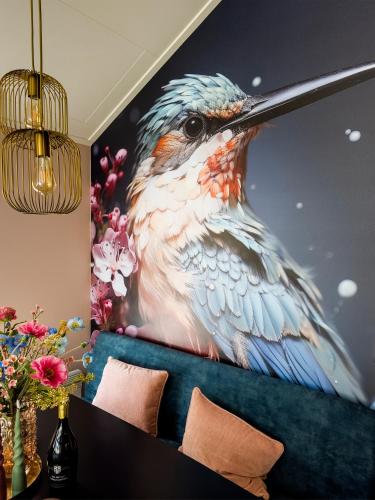 a large painting of a bird on a wall at Royal Resort Cosy Cabin met Hottub in Haarle