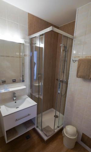 a bathroom with a shower and a sink at NOVAPARK Flugzeughotel Graz in Graz