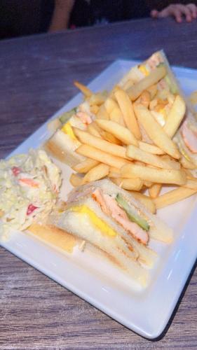 a plate of food with a sandwich and french fries at Room available in one bedroom appartment in Sharjah