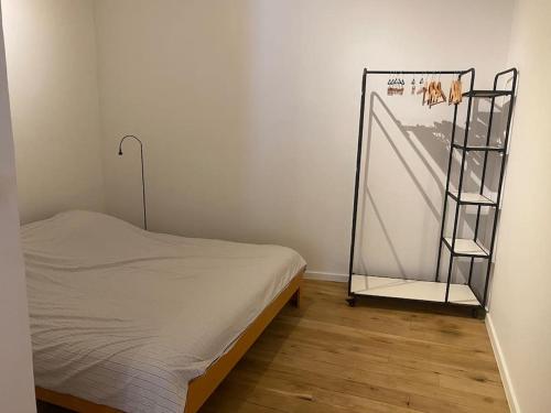 a small bedroom with a bed and a shelf at Studio Richard in Antwerp