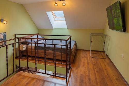 a attic room with a bunk bed and a window at Alpine Retreat Maisonette in Bansko