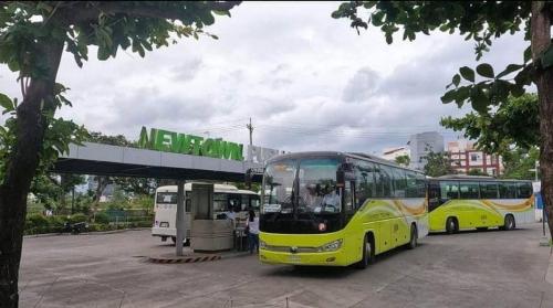 two buses are parked at a bus stop at Cozy 2br with pool and beach access in Punta Engaño